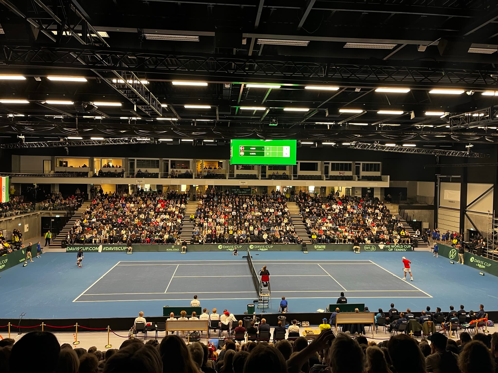 Live tennis match displayed on screen with real-time scoring overlay